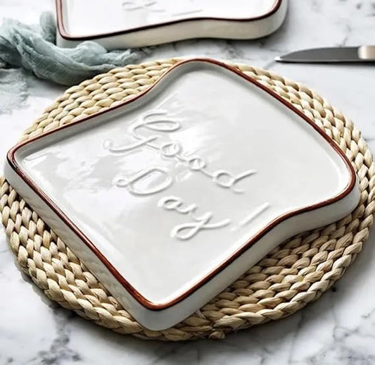 Ceramic tray with 'Good Day' text on a woven mat